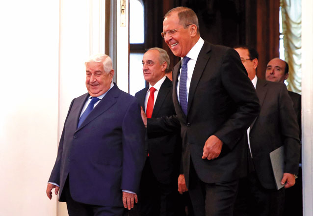 Russian Foreign Minister Sergei Lavrov and Syrian Foreign Minister Walid Al Moualem enter a hall for their talks in Moscow, Russia, on Thursday (Reuters photo)