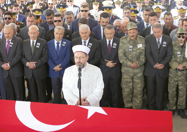 An Imam prays over the coffin of killed Turkish army Sergeant Ozgur Can Ince as relatives and officials stand behind during his funeral at the Ahmet Hamdi Akseki Mosque in Ankara on Friday (AFP photo)
