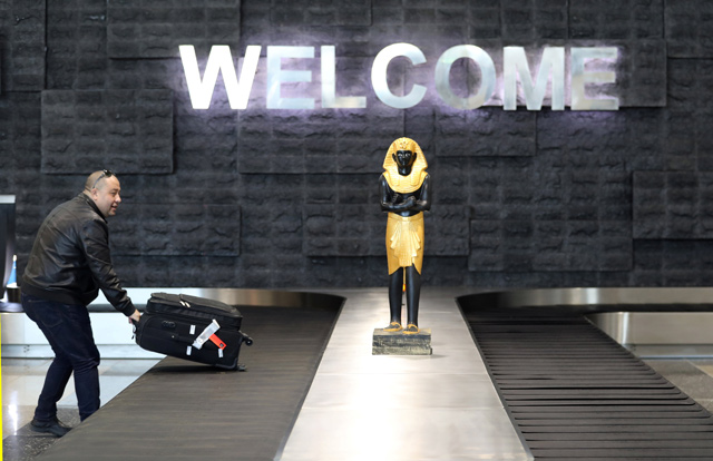 A man takes his luggage after arriving at the new Sphinx International Airport in west Cairo, Egypt, on Saturday  (Reuters photo)