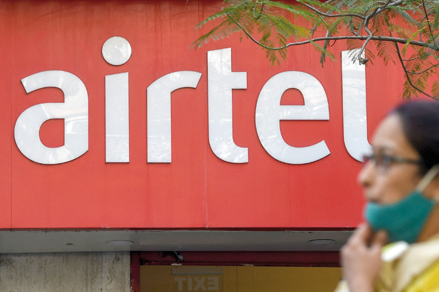 A pedestrian walks past a shop of India’s second-largest mobile operator Airtel in Mumbai on Friday (AFP photo)
