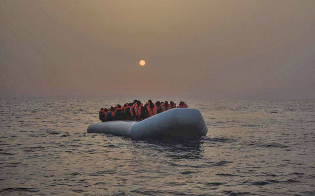 Migrants in orange lifejackets approach the Cypriot coast on a lifeboat on an undisclosed date (File photo courtesy of Kathimerini Cyprus)