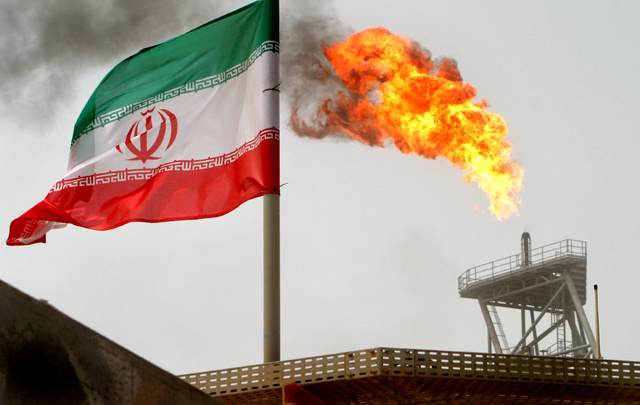 A gas flare on an oil production platform in the Soroush oil fields is seen alongside an Iranian flag in the Arab Gulf, Iran, recently (Reuters photo)