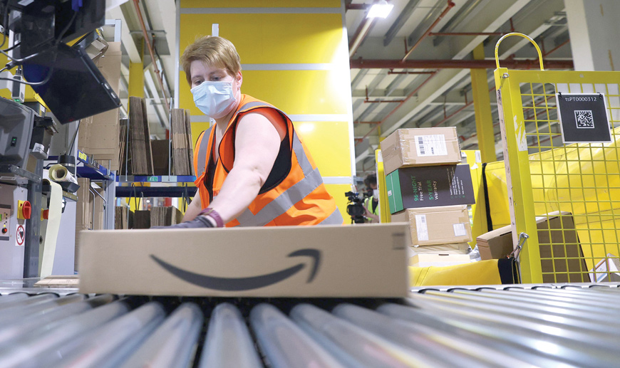 This file photo taken on May 12,  shows an employee preparing a package for shipment at the Amazon logistics centre in Suelzetal near Magdeburg, eastern Germany (AFP photo)