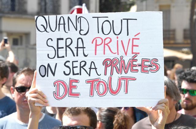 People take part in a demonstration in Montpellier, southern France, on Thursday as part of a multi branch day of protest called by French unions CGT and Solidaires against French president's policies amid a rail strike and spreading student sit-ins. The banner reads 'When all will be private. We will be deprived of all’ (AFP photo)