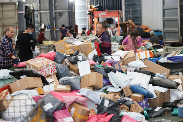 An employee sorts packages for delivery during the Singles Day shopping festival at a logistics centre in Lianyungang, in China's eastern Jiangsu province, on Friday (AFP photo)
