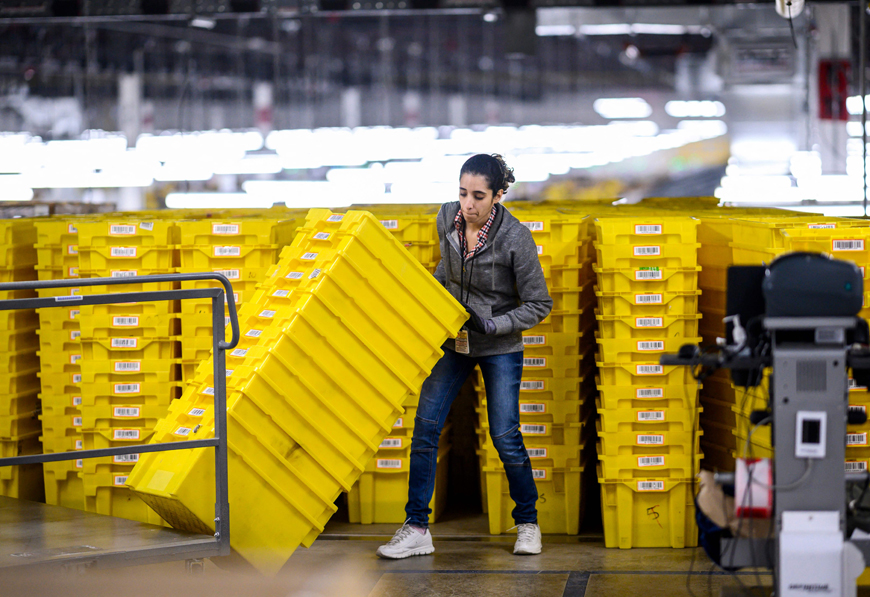 In this file photo, a woman works at a distribution station at the 855,000 square-foot Amazon fulfillment centre in Staten Island, one of the five boroughs of New York City (AFP photo)