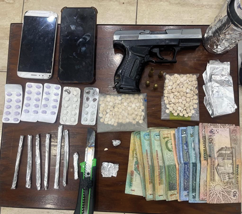Drugs and other items displayed by the authorities following drug raids in Amman on Thursday (Petra photo)
