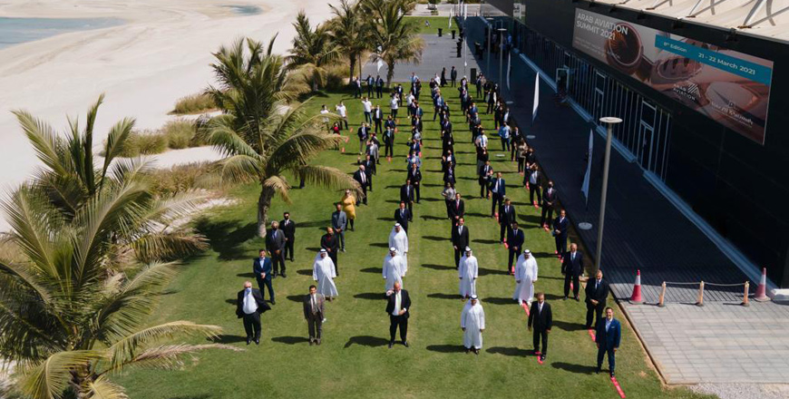 This photo shows participants of the 2021 Arab Aviation Summit (AAS21) in a physically-distanced group photo (Photo courtesy of AAS21)