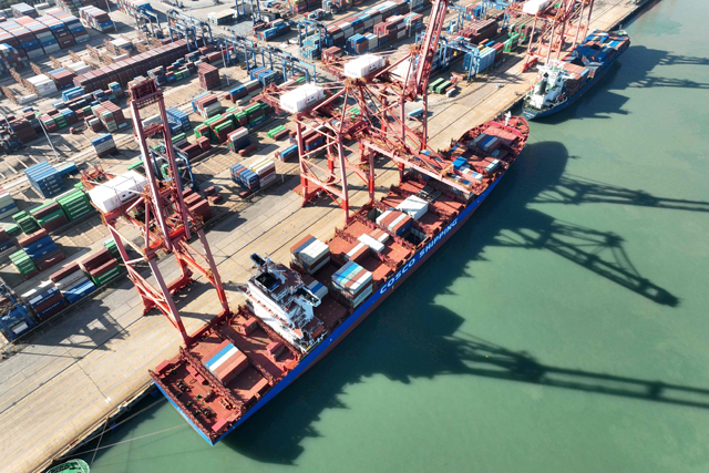 This aerial photo taken on Tuesday shows a cargo ship loaded with shipping containers at Lianyungang Port in China's eastern Jiangsu province (Photo by AFP)
