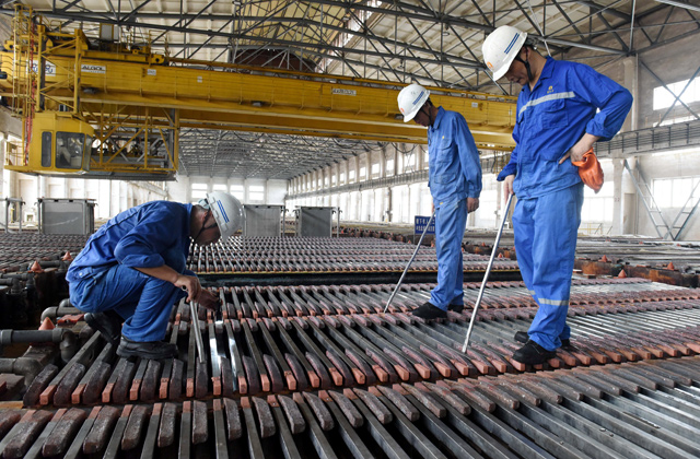 Workers inspect the production of copper cathodes at a Jinlong Copper plant in Tongling, Anhui province, China, on Thursday  (Reuters photo)