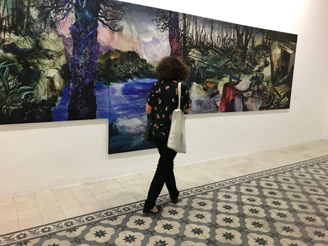 A visitor looks at Ziad Dalloul‘s work titled  ‘The sky is low, the sea is deep (2019)’ (Photo by Johanna Montanari)