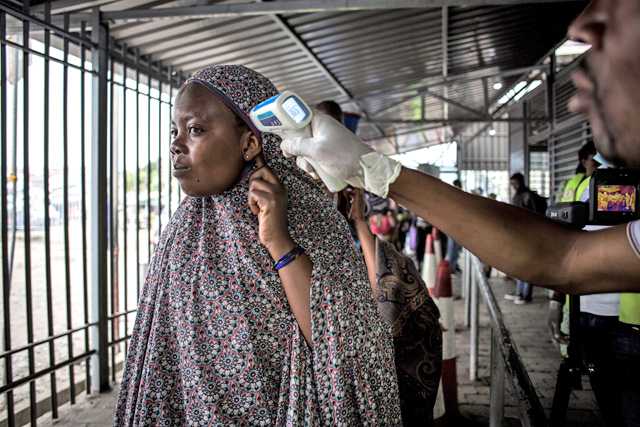 A woman gets her temperature measured at an Ebola screening station as she enters the Democratic Republic of the Congo from Rwanda, on Tuesday, in Goma  (AFP photo)