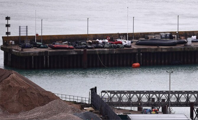 Inflatable dinghies used by migrants on previous attempted crossings of the English Channel from France to England, are pictured stored on the quayside at the harbour at the Port of Dover (AFP photo)