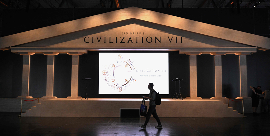 A visitor walks past the booth of 'Sid Meier's Civilization VII', a video game developed by Firaxis Games, during the media day at the Gamescom video games trade fair in Cologne, western Germany on August 21, 2024 (AFP photo)