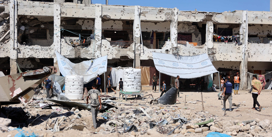 Palestinians check the damage in the al-Zahra school used as a refuge by displaced Palestinians following an Israeli strike, in the Shujaiya neighbourhood of Gaza City on Thursday (AFP photo)