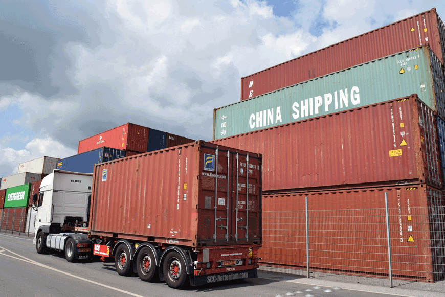 A truck drives past containers piled up at the port in Duisburg, western Germany, on June 26 (AFP photo)