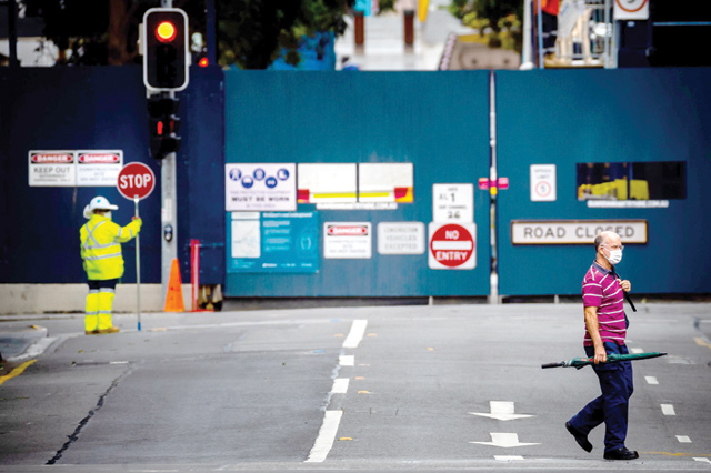 A man crosses a near-deserted street on the first day of a snap lockdown in Brisbane on Saturday (AFP photo)