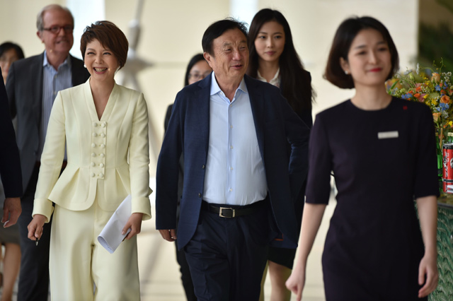 Huawei founder and CEO Ren Zhengfei (centre) arrives to take part in a panel discussion on technology, markets and enterprise in Shenzhen, on Monday (AFP photo)