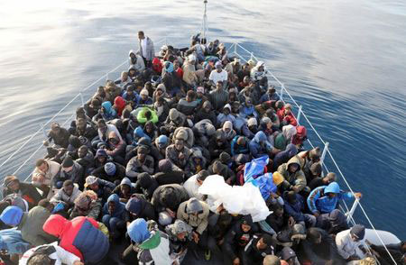 Migrants are seen in a boat as they are rescued by Libyan coast guards in the Mediterranean Sea off the coast of Libya on January 15 (AFP photo)