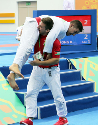 Hamzeh Rasheed’s older brother Haider Rasheed carries him after his victory in a semifinal match at the Asian Indoor and Martical Arts Games (Photo courtesy of Hamzeh Rasheed)