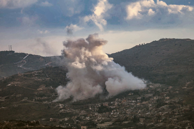 Smoke rises from the site of controlled explosions during demolition activities undertaken by the Israeli army in the southern Lebanese village of Kfarkila yesterday (AFP photo)