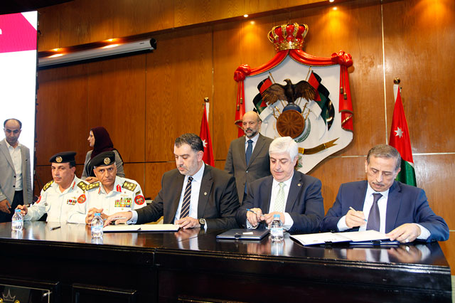 Prime Minister Omar Razzaz attends the signing of agreements between the Labour Ministry and 30 public institutions and private companies on Tuesday (Petra photo)