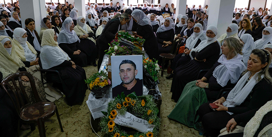 Women gather around casket of Zaher Bishara, a Druze man from the village of Ein Qiniyya in the Israel-occupied Golan heights, killed in an industrial building when Hizbollah fighters fired a barrage of rockets at Kiryat Shmona from neighbouring south Lebanon, on Wednesday (AFP photo)