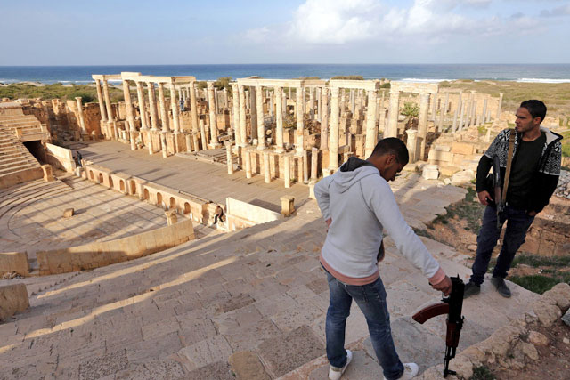 Libyan men guard the amphitheatre in the ancient Roman city of Leptis Magna in Al Khoms, 130 km east of the Libyan capital Tripoli, on Sunday (AFP photo)