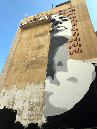   A portrait of a woman painted on an eight-floor building on Arar Street in Amman; a collaborative project between two young artists showcased during the ‘16 Days of Activism Against Gender-Based Violence’ (Photo by Maria Weldali)