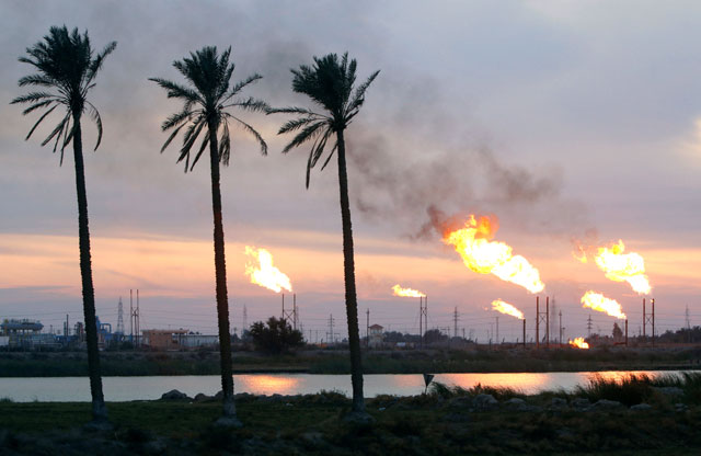 Flames emerge from flare stacks at the oil fields in Basra, Iraq, January 17 (Reuters photo)