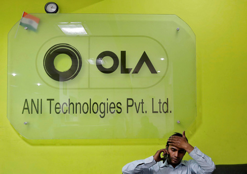 An employee speaks over his phone as he sits at the front desk inside the office of Ola cab service in Gurugram, previously known as Gurgaon, on the outskirts of New Delhi, India, on April 20, 2016  (Reuters file photo)