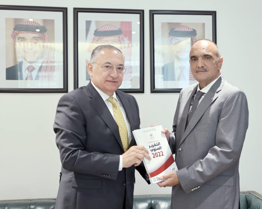 Prime Minister Bisher Khasawneh receives a copy of Integrity & Anti-Corruption Commission annual report for the year 2022 from IACC Chairman Muhannad Hijazi on Monday (Petra photo)