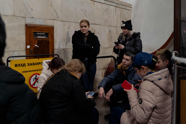 Residents take shelter in a metro station after an air raid warning was issued in Kyiv yesterday amid the Russian invasion of Ukraine (AFP photo)