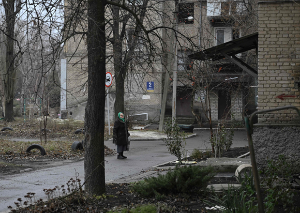 An elderly woman stands in a deserted alley in Pokrovsk yesterday as Russian troops advance close to the city (AFP photo)