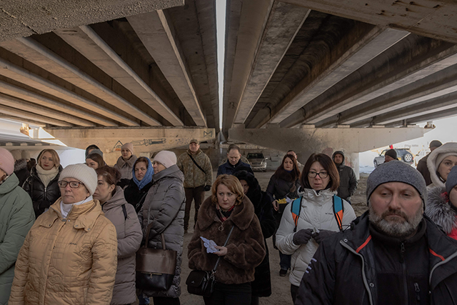 Local residents attend a memorial ceremony under a destroyed bridge in Irpin, northwest of Kyiv today (AFP photo)