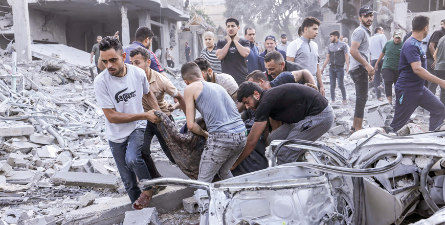 Palestinians evacuate a victim following an Israeli air strike on Rafah, in the southern Gaza Strip, on Tuesday (AFP photo by Mohammed Abed)