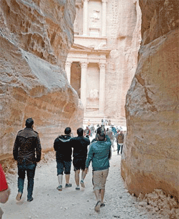 Tourists take photos of Petra’s Treasury, the rose-red city’s iconic façade, as they walk through the Siq, a 1.2km-long gorge leading to the Treasury, 235km south of Amman, in this file photo  (JT file photo)