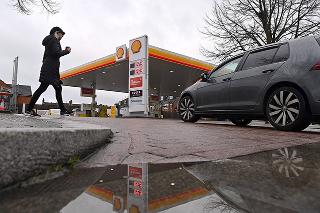 A Shell service station is reflected in a puddle in London, in this photo taken on February 04, 2021 (AFP file photo)