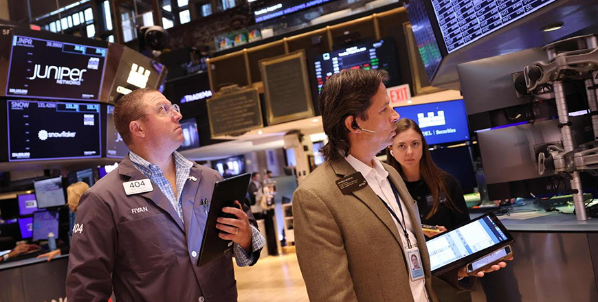 Traders work on the floor of the New York Stock Exchange during morning trading on Tuesday in New York City (AFP photo)