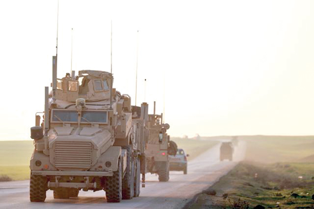 US Marine Corps tactical vehicles are seen driving along a road near the town of Tal Baydar in the countryside of Syria’s northeastern Hasakeh province on Friday  (AFP photo)