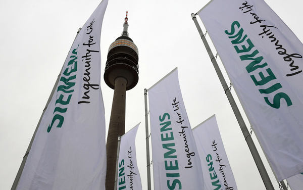 In this file photo taken on January 30, 2019, flags of the German engineering giant Siemens are seen in front of the Olympic hall ahead the company's annual shareholder's meeting in Munich, southern Germany (AFP photo)