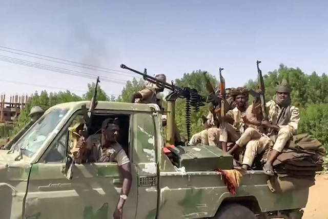 In this image grab taken from handout video footage released by the Sudanese paramilitary Rapid Support Forces (RSF) on April 23, 2023, fighters ride in the back of a technical vehicle (pickup truck mounted with a turret) in the East Nile district of greater Khartoum (AFP photo)