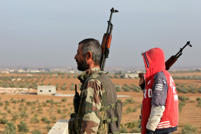 Turkey-backed Syrian fighters stand guard in Jarabulus, close to the border with Turkey in the rebel-held north of Syria's Aleppo province, on Monday (AFP photo)