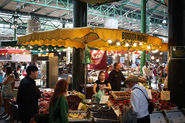 People shop for fruit and vegetables at Borough Market in London on Friday (AFP photo)