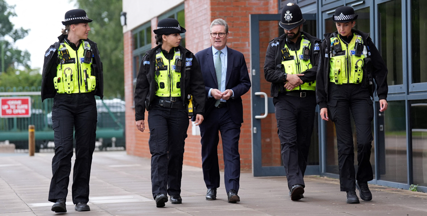 Britain's Prime Minister Keir Starmer (centre) speaks with members of the West Midlands Police Force at Arden Academy in Solihull, West Midlands, on Thursday (AFP photo)