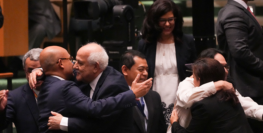Palestinian representative Ryad Mansour is congratulated on the result of a vote during the emergency session on the legal consequences of Israel's actions in the Palestinian territories at United Nations Headquarters on Wednesday in New York  (AFP photo)