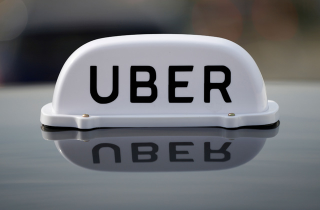 The logo of taxi company Uber is seen on the roof of a private hire taxi in Liverpool, Britain, on April 15, 2019  (Reuters file photo)