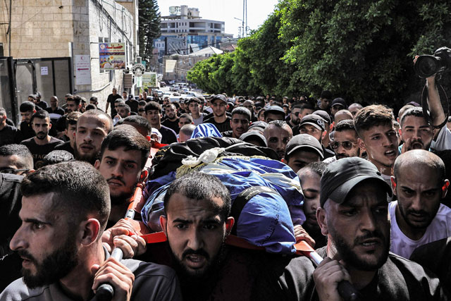 Mourners carry the body of Saeed Izzat Jaber, 24-year-old member of the Palestinian armed group Islamic Jihad, who was killed during bombardment on the Nur Shams camp for Palestinian refugees, east of Tulkarm in the occupied West Bank, on Sunday (AFP photo)
