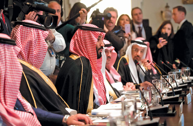 Saudi Arabia's Crown Prince Mohammed Bin Salman (centre) speaks alongside members of his delegation during a lunch meeting with US President Donald Trump in the Cabinet room of the White House in Washington, DC, on Tuesday (AFP photo)