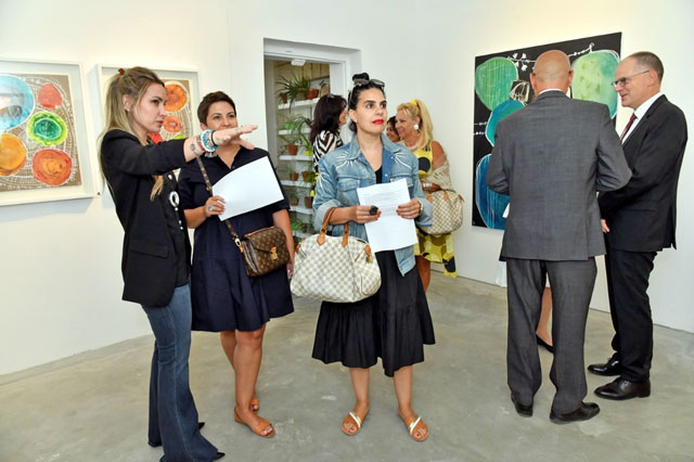 Jordanian artist Nissa Raad (far left) speaks with patrons of her new ‘UM’ exhibition focusing on motherhood at the Wadi Finan Art Gallery in Amman on Tuesday (Photo courtesy of Wadi Finan Art Gallery)